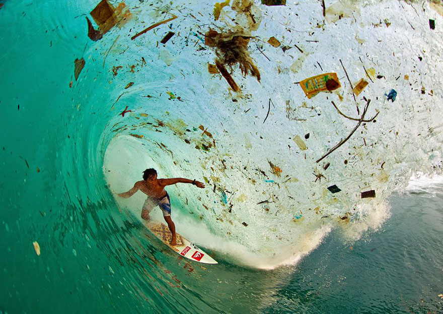 Surfing on a wave full of trash in Java (Indonesia), the world’s most populated island