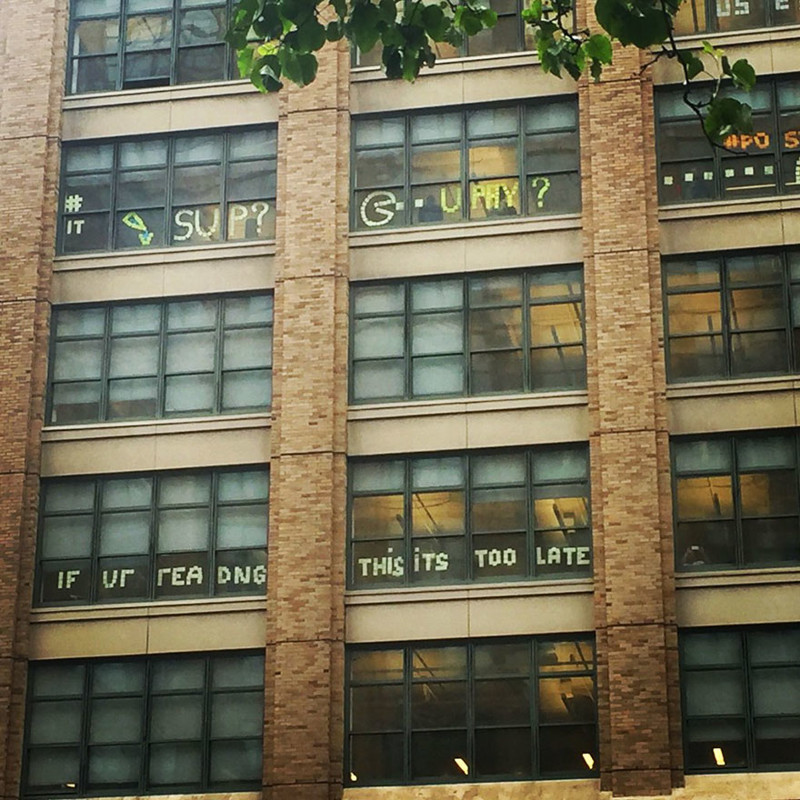 Soon, “Sup” appeared on a building from across the street at 200 Hudson