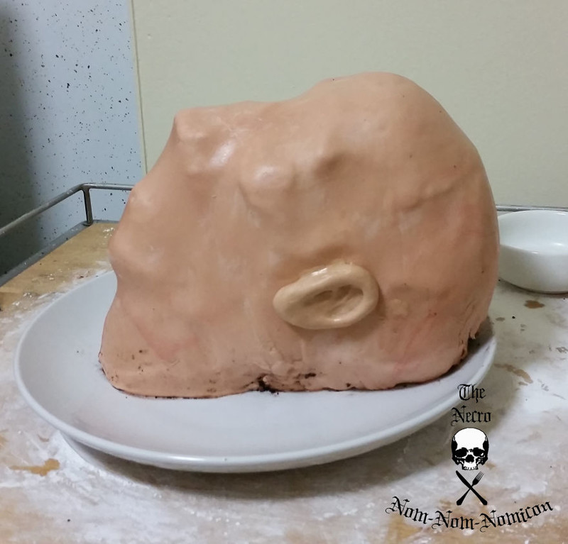 Once the skull is painted, I carefully apply a layer of marshmallow fondant (I even made ears!)