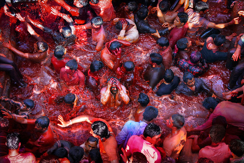 #13 Hindus Immersing Themselves In A Pool FIlled With Colored Water During Holi In Nasik, India