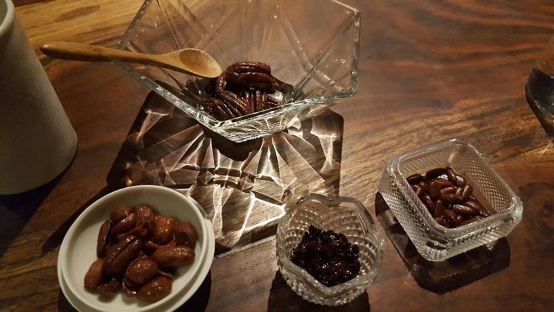 “Accompanying assortment of candied toppings (walnuts, peanuts, cacao nibs and pine nuts)”