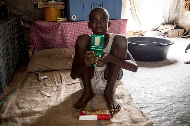 In a Haitian home living on $102/month per adult, the favorite toy is a handheld video game