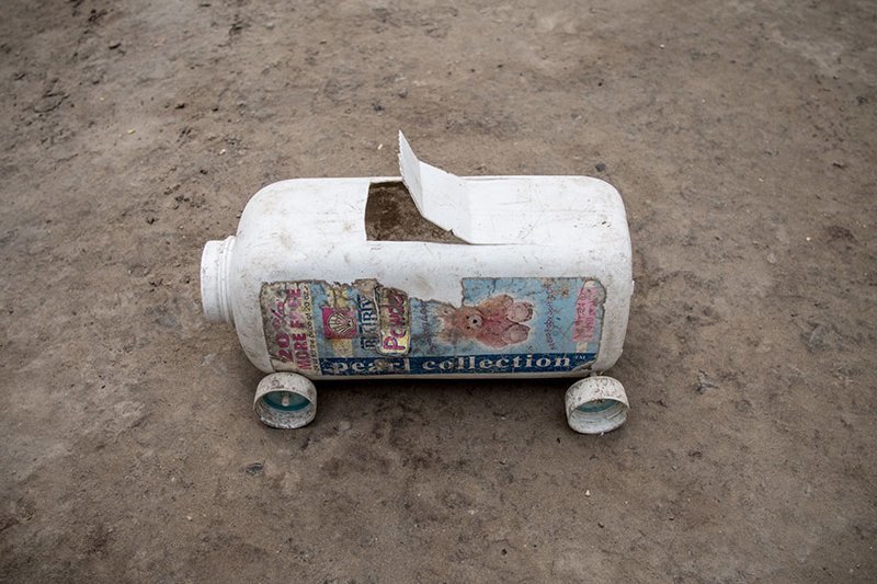 In a Haitian home living on $39/month per adult, the favorite toy car made out of recycled plastic items