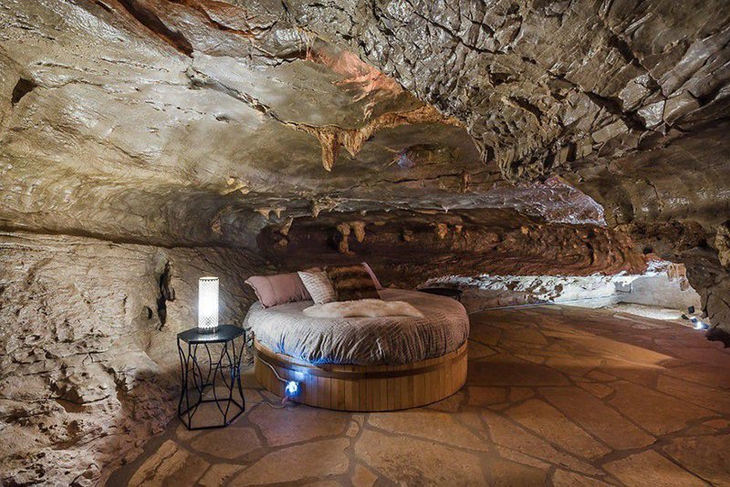 The spacious master includes a unique round queen-sized bed and a spa-like private bathroom, all surrounded by the natural formations of the cave