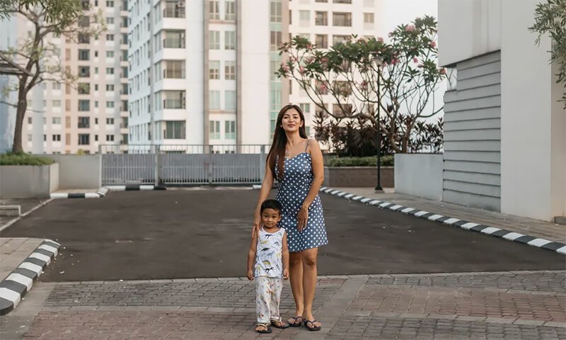 Indri Lestari and her son, who moved to Cosmo Park three months ago.