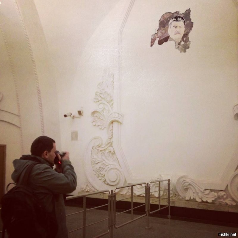 Москва, станция Арбатская. Отвалился кусок штукатурки со стены и стал виден фрагмент старой Советской мозаики.
То была не просто мозаика. И проявился не просто фрагмент.